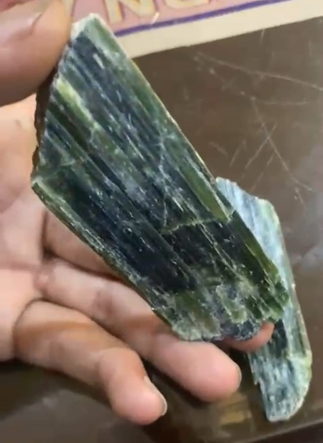 Dark green, fibrous nephrite in hand.